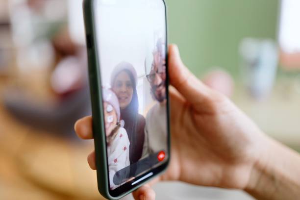 istock Happy family having a video call with a friend 2178541272