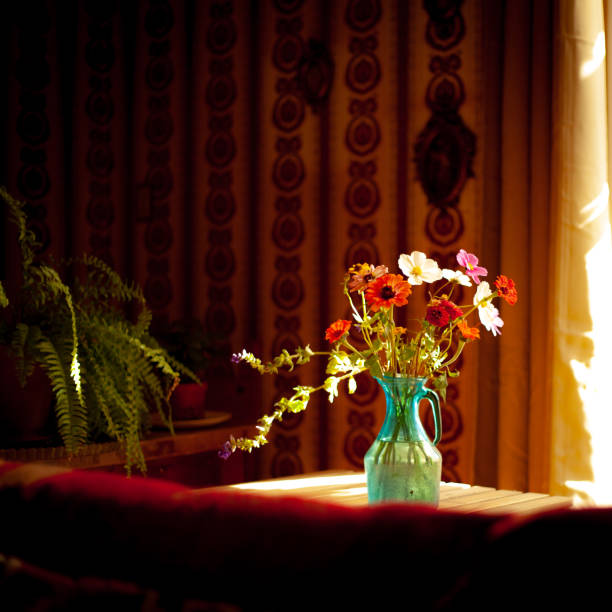Sunflowers and assorted flowers arranged in a glass vase