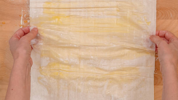 istock Brush each layer of phyllo dough with melted butter, step by step baking process 2178548533