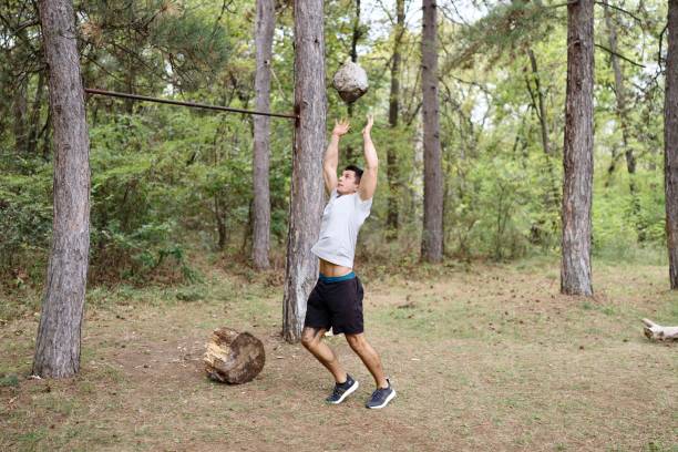 Military soldier climbing rope during obstacle course in boot camp