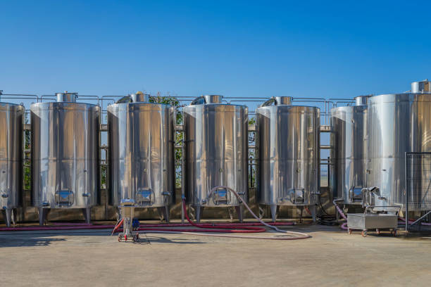 istock Industrial winemaking equipment with multiple tanks outside in open air 2178550210