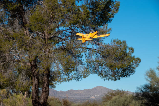 istock Yellow RC plane taking off into a blue sky 2178550342