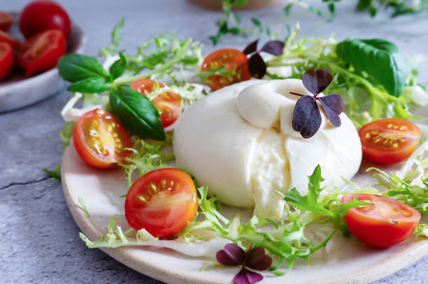 istock Creamy burrata cheese paired with basil leaves and tomatoes. 2178551486