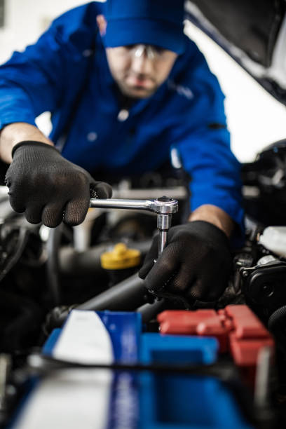 istock A mechanic works on a vehicle's engine in a workshop using a ratchet wrench to perform repairs and maintenance during the day 2178551625