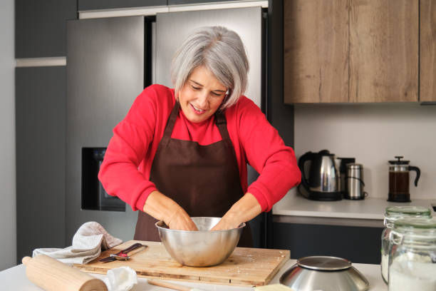 istock Senior woman kneading dough baking Christmas cookies in her kitchen 2178552698