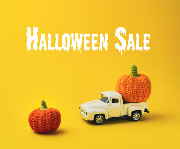 istock White truck is carrying two orange pumpkins 2178554513