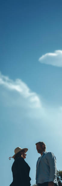 istock Couple together on blue sky background, close up 2178559104