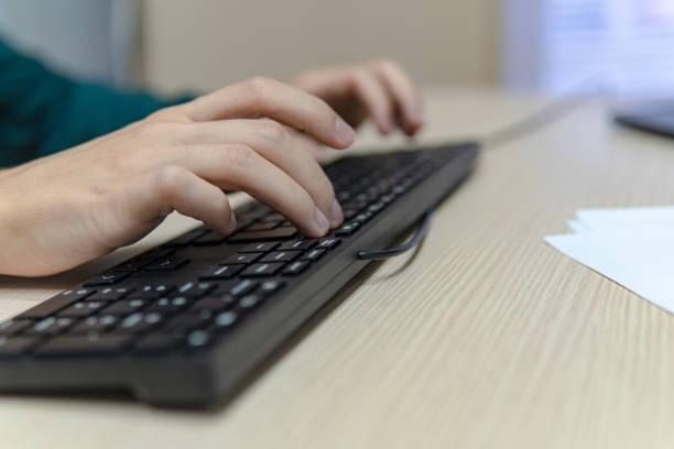 istock Close up businessman hands using a computer in the office, side view, typing the keyboard, business concept 2178561421