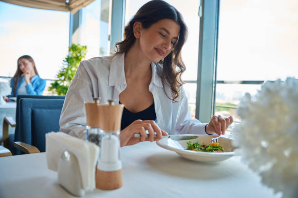 istock Dark-haired smiling woman having her meal at the restaurant 2178562027