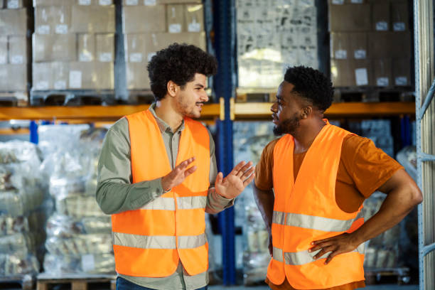 istock Interracial warehouse manager talking to his black migrant employee and giving him tasks. 2178563975