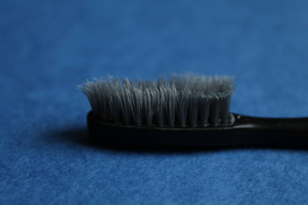 toothbrush on a blue background, side view. How to choose the right toothbrush.