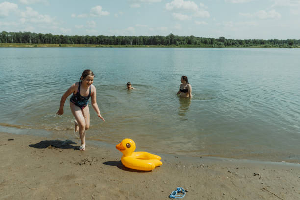 istock Happy family playing at the lake with inflatable duck float 2178565966