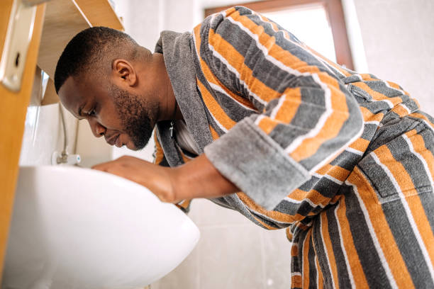 istock Young man having morning routine in bathroom at home brushing teeth 2178569087
