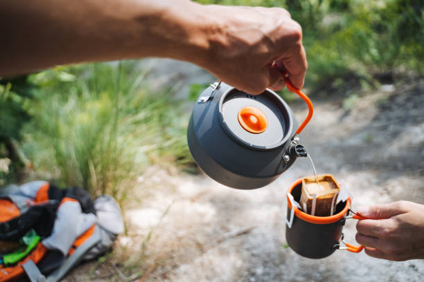 istock Elevate your camping experience with a hot beverage from a kettle, sipping it from a mug while hiking in nature on a beautiful trail, surrounded by greenery and serenity 2178573101
