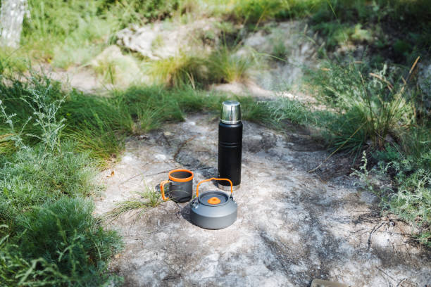 istock Enjoy outdoor camping with camping equipment including a thermos and foldable kettle amidst rocky terrain. Embrace nature and adventure in the scenic wilderness 2178573103