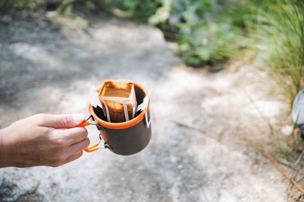 istock In the image, a person delicately holds a coffee cup brimming with coffee beans, evoking a tranquil and soothing atmosphere that captures the beauty of the present moment 2178573111