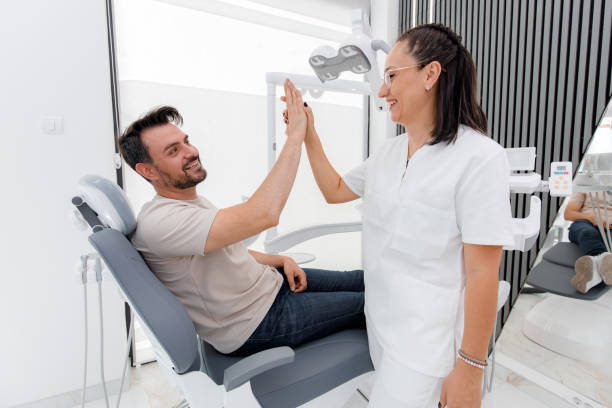 istock A patient and dentist share a friendly high-five in a modern dental office during an appointment 2178573611