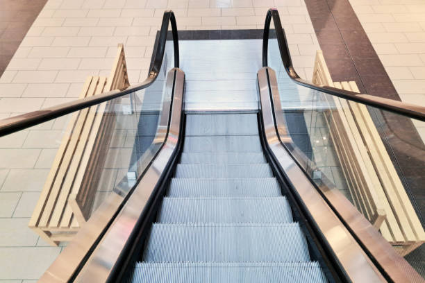 istock Escalator in a shopping mall. Automatic stairs at a train station. Modern retail environment. 2178573665
