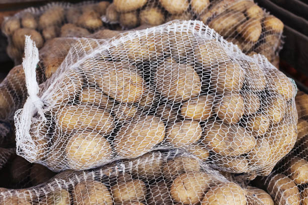 istock Potatoes in a sack. Natural eco-friendly vegetables. Freshly harvested potatoes with rustic texture. Organic produce in a burlap bag. 2178574298