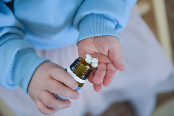 A child holds several tablets in his hand stock photo