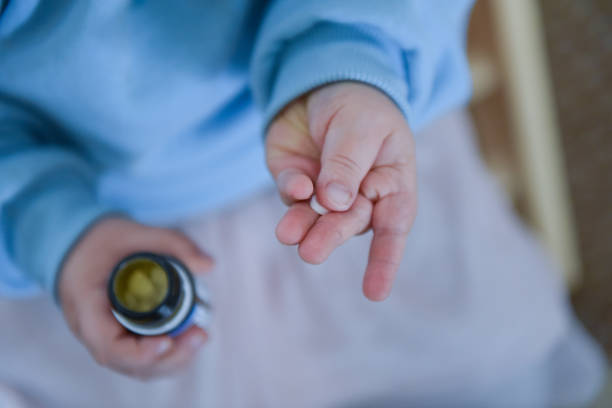 A child holds several tablets in his hand stock photo