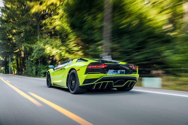 Lamborghini Huracán STO sports car driving on a street in Zwolle, Netherlands. The STO is a high performance edition of the Lambo Huracan with extreme aerodynamics, track-honed handling dynamics, lightweight contents and a high performing V10 engine. Photo with motion blur emphasizing the speed of the car.
