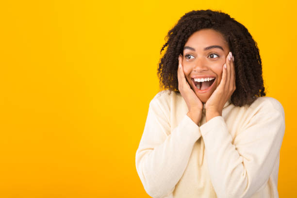 istock Shocked african american girl screaming and holding cheeks 2178581621