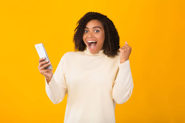 istock Excited african girl holding iPhone 11 pro max 2178581628