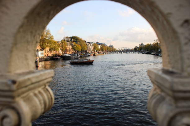 istock Amsterdam canal view with boat 2178582058