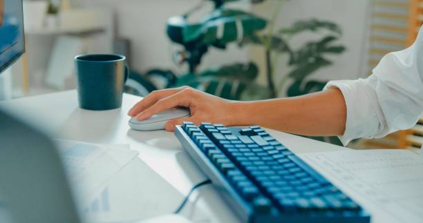istock Close-up of hands young Asian man typing on keyboard in home office, highlighting remote work, financial planning, and modern technology. Remotely and finance. 2178582942