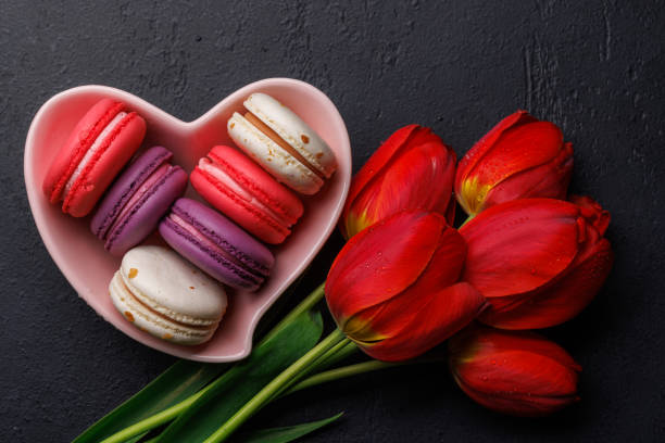 istock Red tulips and vibrant macaroons fill a heart-shaped bowl 2178583101