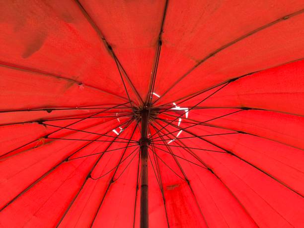 istock Broken red umbrella. Abstract red background. Vendor umbrella 2178583361