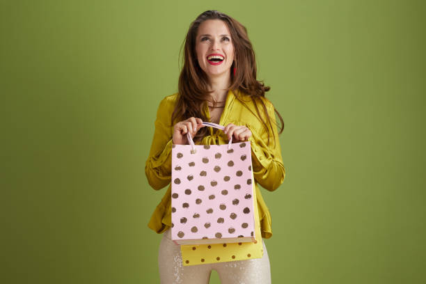istock happy modern woman looking up against green background 2178585807