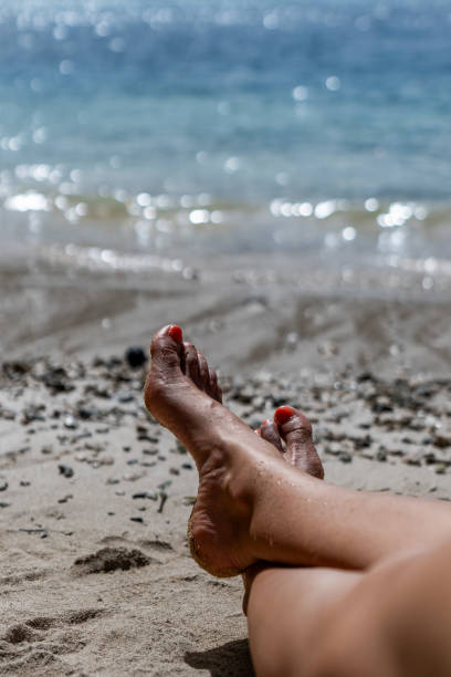 istock Woman feet in barefoot on the beach 2178586957