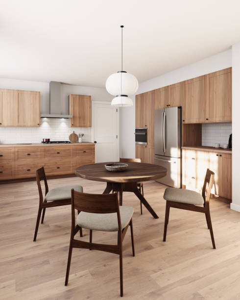istock This stylish kitchen features wooden cabinetry, an inviting dining table, and elegant, chic lighting 2178587579