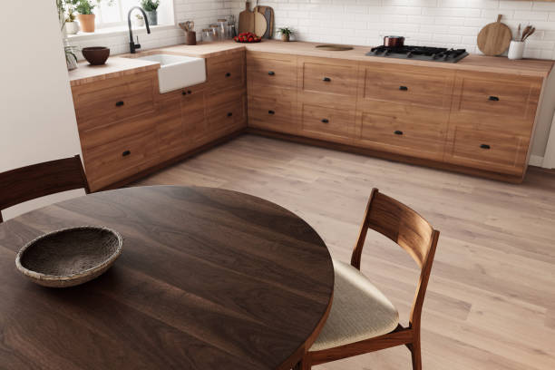 istock This stylish, modern kitchen showcases beautiful wooden cabinetry and features a charming round dining table 2178587589