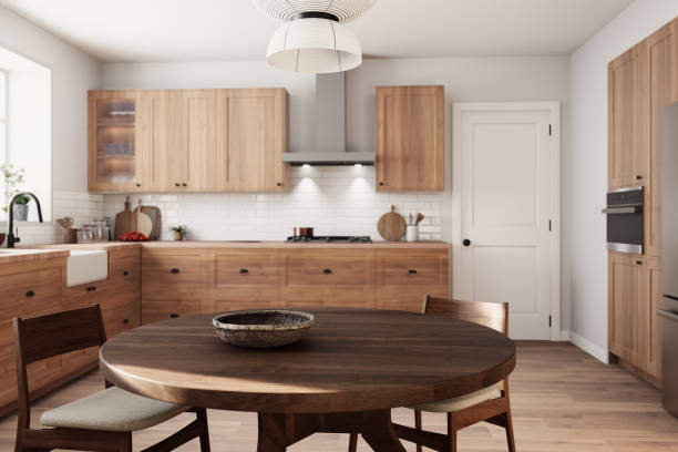 istock This stylish wooden kitchen setup showcases a beautiful round dining table along with ample storage options. 3d render 2178587590