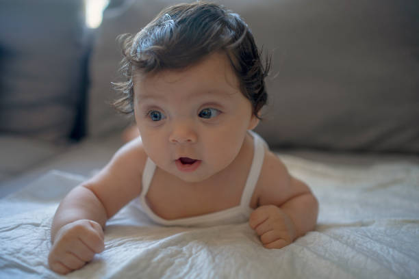 istock a baby on a bed, it is a very cute 2178587616