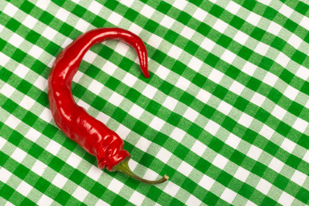 red hot pepper on a green tablecloth