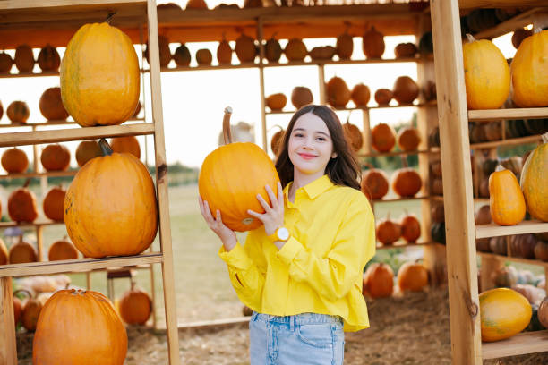 istock girl on a pumpkin farm, Halloween pumpkin patch 2178589502