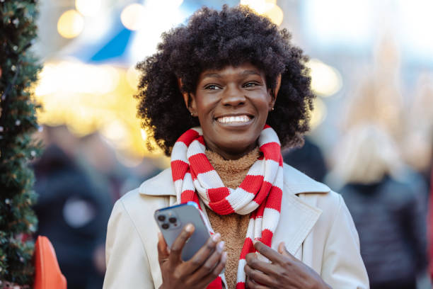istock Joyful woman smiling outdoors in a festive holiday setting 2178592107