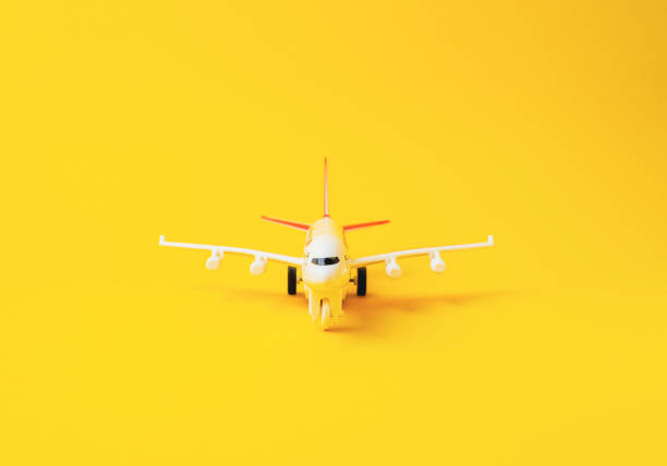 istock Yellow toy airplane is sitting on a yellow background 2178594563