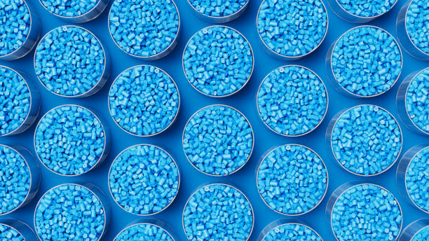 Top view on grid of glasses filled with blue plastic polypropylene granules, masterbatch polymer grain. HDPE or PVC resin pellets. 3d render illustration