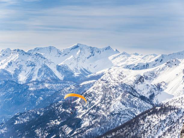 istock Paraglider over snowy mountains at Serre Chevalier 2178600293