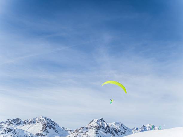 istock Paraglider over snowy mountains at Serre Chevalier 2178600300
