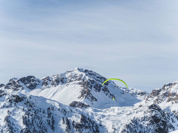istock Paraglider over snowy mountains at Serre Chevalier 2178600315
