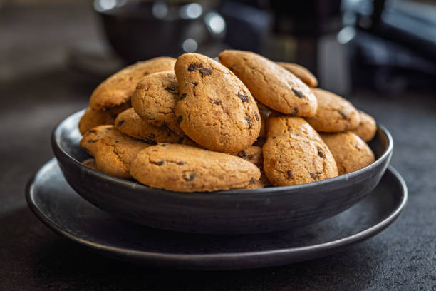 istock Shortbread cookies with chocolate chips. Chocolate cookies on plate on black table. 2178600456