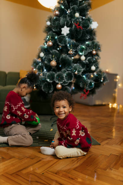 istock Cute boy enjoying board game near christmas tree during holidays 2178604016