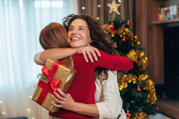 istock Female friends exchanging Christmas gift 2178607226