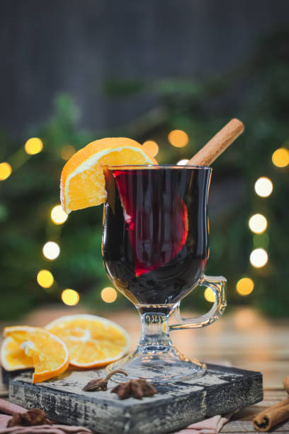istock Glass of red wine mulled wine with cinnamon and orange on a cutting board on a table . 2178607891